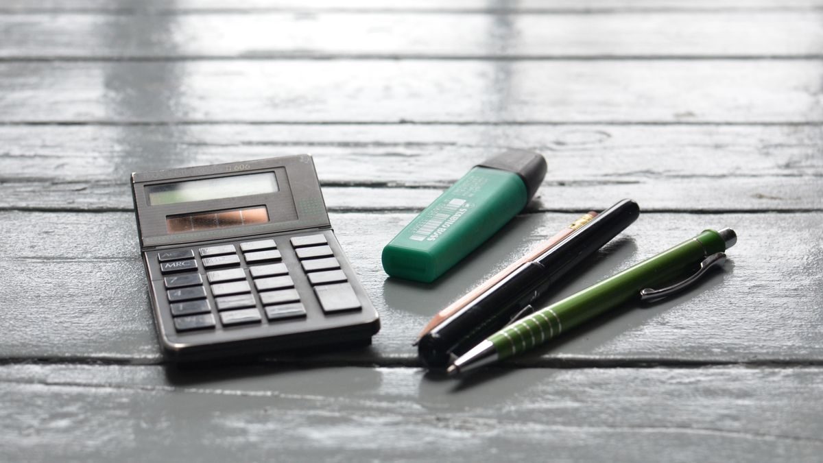Calculator and pen on a desk