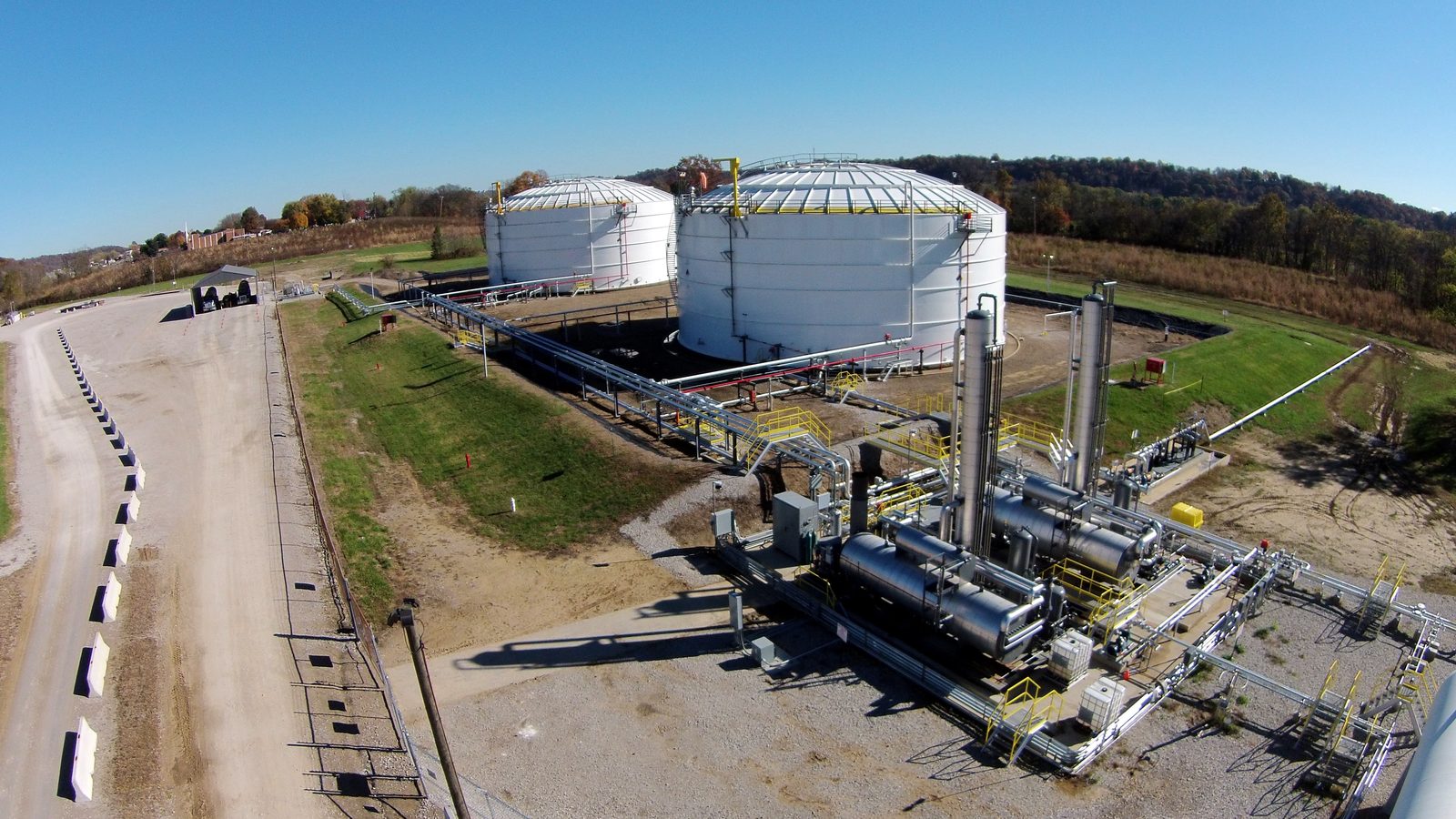 Aerial view of a bulk storage tank farm with process piping and loading infrastructure