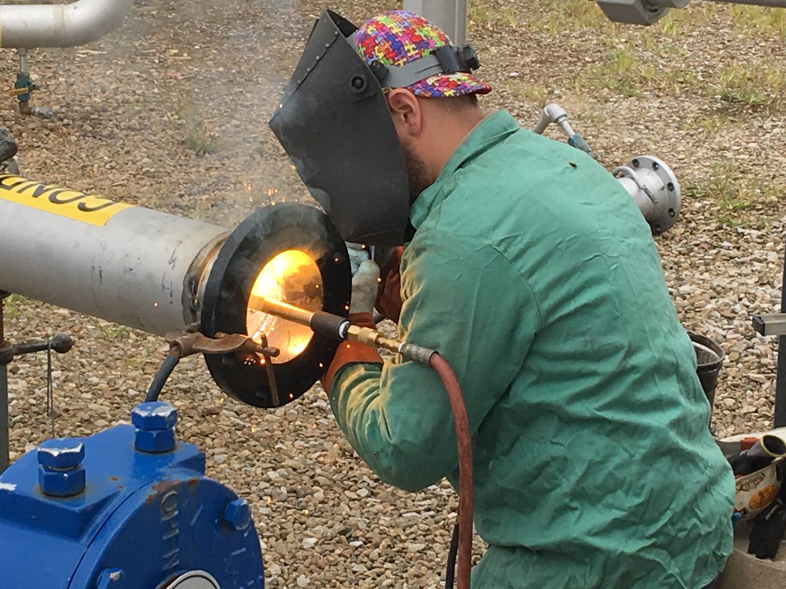 A welder joining process piping at a terminal with a cutting torch